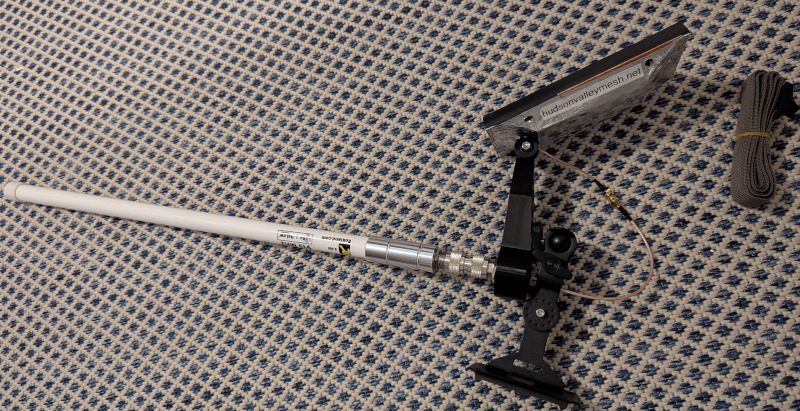 A photo of a game camera mount attached to 3d printed mount with panel and antenna