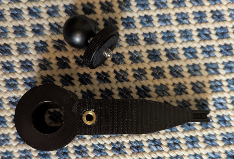 A photo of a heat inset screw fit into a 3d printed mount